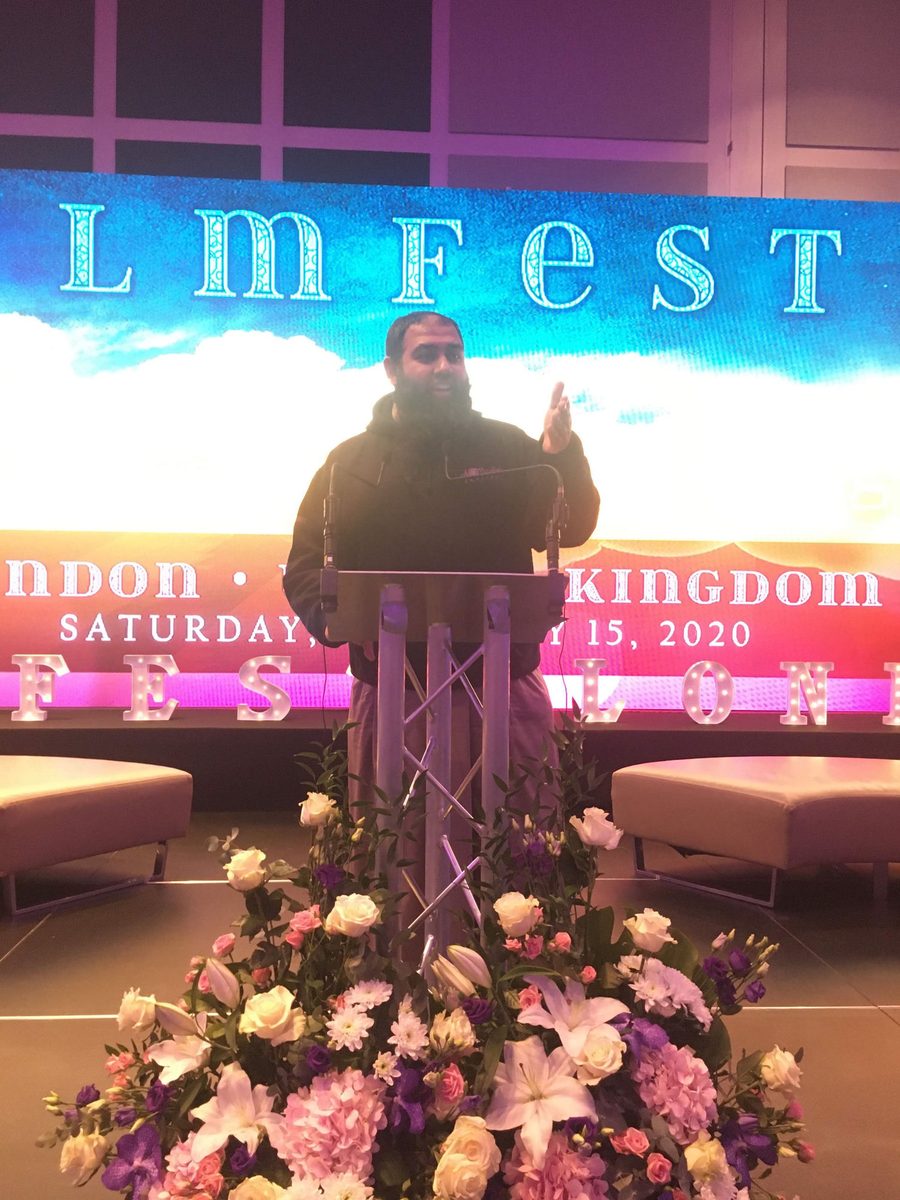 Mohammad Arshad speaking on stage